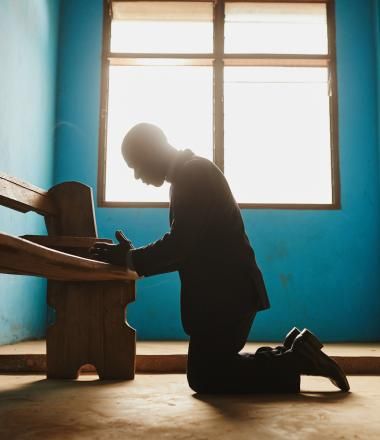 Man kneeling to pray in Ghana