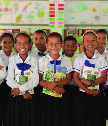 children standing in school with books