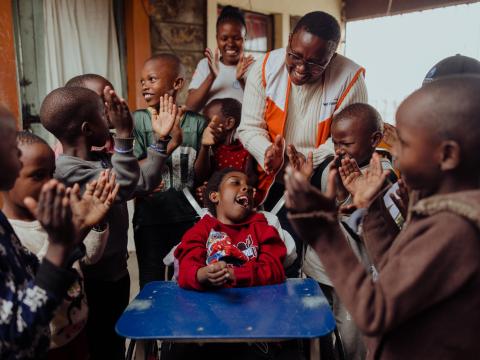 World Vision staff member with child with special needs in Kenya