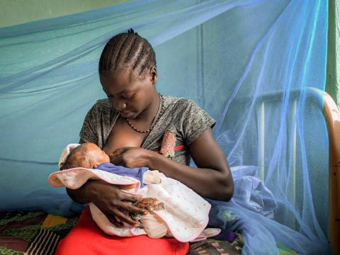 Viola breastfeeds her child in South Sudan.