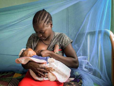 Woman breastfeeds her baby