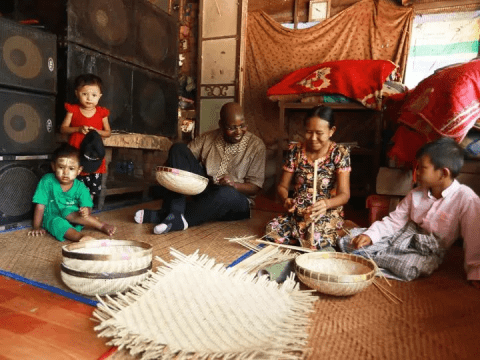 JBK visits a small house in Myanmar and sits with a family