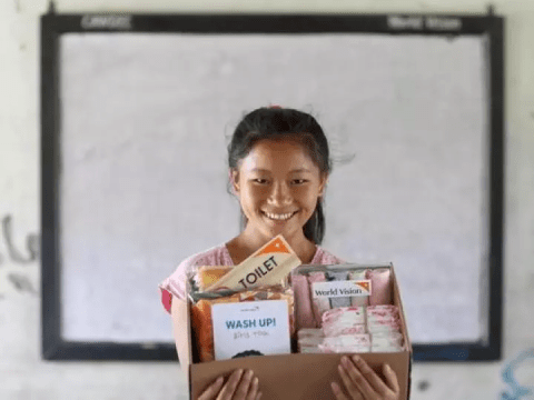 A girl holds a WV Nepal sponsored hygiene kit. 